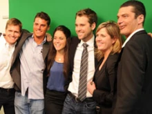 Participants in Holy Wood's grand opening pose in front of a green screen