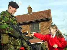 A pupil from Holy Cross Girls' School with a soldier from the Argyll and Sutherland Highlanders. 