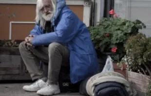 A homeless man sits with his belongings.   Franco Folini (CC BY-SA 2.0)