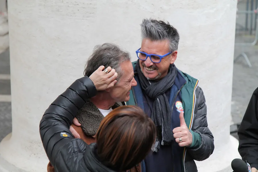 Volunteers embrace Polish homeless man Gregorio after he visits the Vatican's new shower and barbershop facilities. ?w=200&h=150