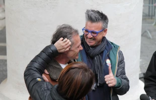 Volunteers embrace Polish homeless man Gregorio after he visits the Vatican's new shower and barbershop facilities.   Bohumil Petrik/CNA.