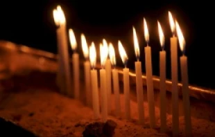 Candles lit in the Church of the Holy Sepulchre in Jerusalem, Israel.   Lauren Cater/CNA.