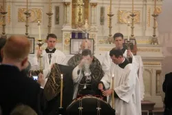 Fr. John Berg, FSSP, incenses the casket of Fr. Kenneth Walker at the the conclusion of his funeral Mass in Paxico, Kan., June 20, 2014. ?w=200&h=150