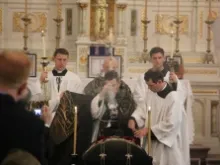 Fr. John Berg, FSSP, incenses the casket of Fr. Kenneth Walker at the the conclusion of his funeral Mass in Paxico, Kan., June 20, 2014. 