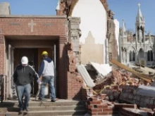 Workers begin to remove debris from the grounds of the 110-year-old St. Joseph's Catholic Church on March 1, 2012 in Ridgway, Illinois. 