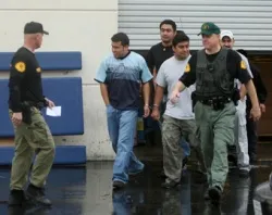 Immigrants are detained by sheriff's deputies outside of a DVD manufacturing company in Santa Clarita, Calif. in Feb. 2009. ?w=200&h=150