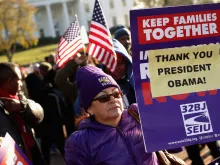 About 100 people gather to rally in support of President Barack Obama's executive action on immigration policy across from the White House Nov. 21, 2014. 