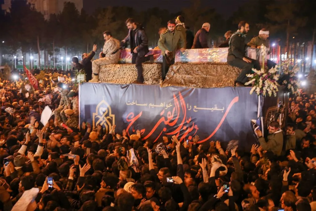 Iranians gather around the caskets of Qasem Soleimani and others during a funeral procession after the bodies arrived in Qom, Jan. 6, 2020. ?w=200&h=150