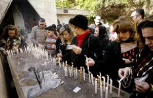 Iraqi Christians light candles affter attencing Christmas Mass in Baghdad on Dec. 25, 2008.   Wathiq Khuzaie/Getty Images.