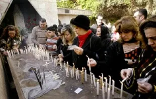 Iraqi Christians light candles after attending Christmas Mass in Baghdad on Dec. 25, 2008.   Wathiq Khuzaie/Getty Images News.