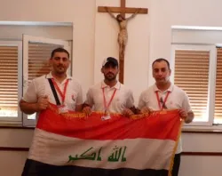 Iraqi Christians before the cross.?w=200&h=150