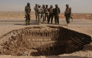 Iraqi and U.S. army members look over a bridge damaged by a vehicle-borne IED in Mosul, Iraq, March 22, 2008.   U.S. Air Force photo by Staff Sgt. Jason Robertson.
