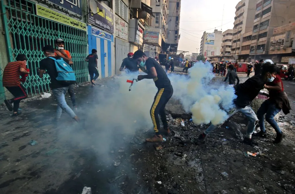 Iraqi protesters run from tear gas fired by security forces at Baghdad's Khallani square during ongoing anti-government demonstrations, Nov. 12, 2019. ?w=200&h=150