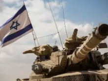 An Israeli tank moves positions near the Israeli-Gaza border the morning of July 18, 2014 near Sderot, Israel. Late last night Israel sent troops into Gaza. 
