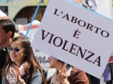 Participants in Italy's 2014 March for Life carry a sign reading "Abortion is Violence." 