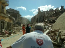 Rescue workers from the Sovereign Military Order of Malta assist in an earthquake affected area, Aug. 24, 2016. 