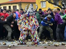 People throw turnips at a man representing the Jarramplas, in Piornal on January 19, 2017 during the annual San Sebastian festivities.  