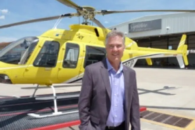 Jeff Puckett stands in front of his Bell 407 helicopter hes dubbed PrayerOne Credit Hillary Senour CNA US Catholic News 5 16 13