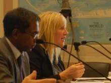 Jill McElya, a human rights lawyer with the Invisible Girl Project, answers a question as Dr. Sabu M. George (R) listens on Sept 9, 2013. 