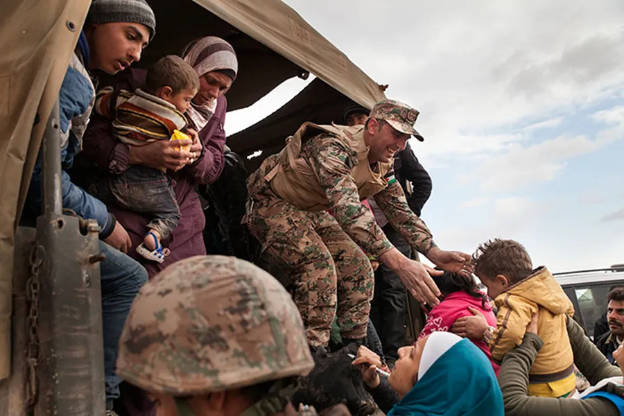 Jordanian troops and UNHCR officials help bring Syrian refugees to Jordan's Zaatari refugee camp. ?w=200&h=150