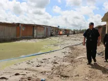 Archbishop Jose Eguren of Piura visits a town affected by flooding. 