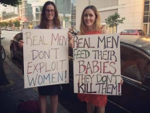 Kate Bryan and her friend display the signs they held at a Sept. 26 Men for Choice rally in Washington, D.C. Photo courtesy of Kate Bryan.