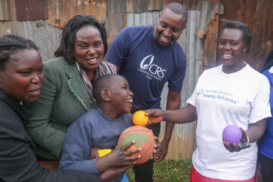 Staff and volunteers with a client at a Catholic Relief Services early childhood development center in Nairobi, Kenya. ?w=200&h=150