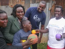 Staff and volunteers with a client at a Catholic Relief Services early childhood development center in Nairobi, Kenya. 