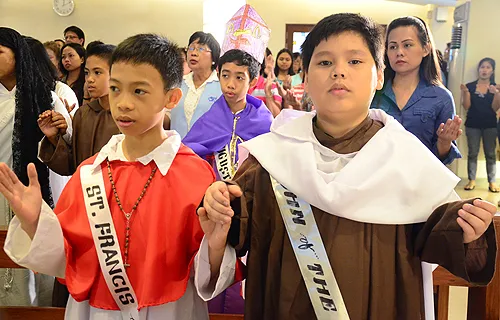 Filipino children pray during a March of Saints.?w=200&h=150