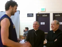 LA Lakers player Pau Gasol talks with Archbishop Jose Gomez and Cardinal Juan Luis Cipriani.
