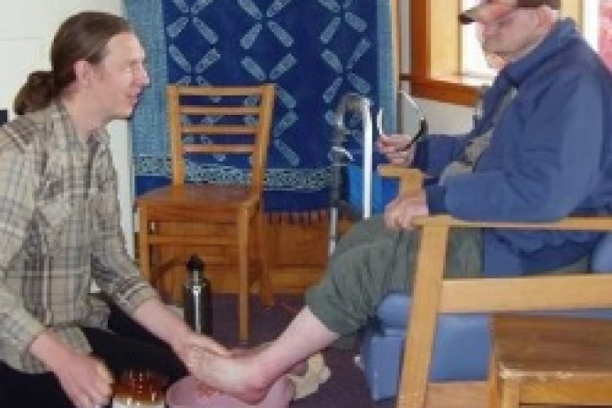 LArche volunteer washes the feet of resident CNA