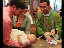 (L-R) Don, Erin, and Theodore Marek, and Fr. Luis Granados. 