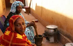 (L-R) Fatimata Toure and her sister Hawa prepare a meal at their relatives' home in Bamako, Mali. Photo by Helen Blakesley/Catholic Relief Services.?w=200&h=150