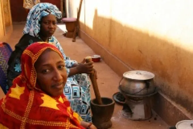 L R Fatimata Toure and her sister Hawa prepare a meal at their relatives home in Bamako Mali Photo by Helen Blakesley Catholic Relief Services CNA 1 25 13