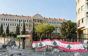 Lebanese flag on barbed wire in front of the Lebanese government seat of Grand Serail.   JossK/Shutterstock.