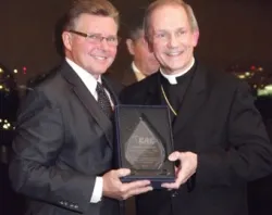 Legendary NHL referee Kerry Fraser poses with his award and Bishop Thomas Paprocki of Springfield on Oct. 9, 2012. ?w=200&h=150