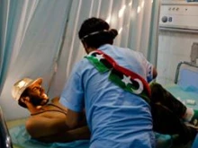 A rebel fighter grimaces as he receives medical attention for a gun wound to the shoulder at Tripoli Central Hospital on August 25, 2011 in Tripoli, Libya. 