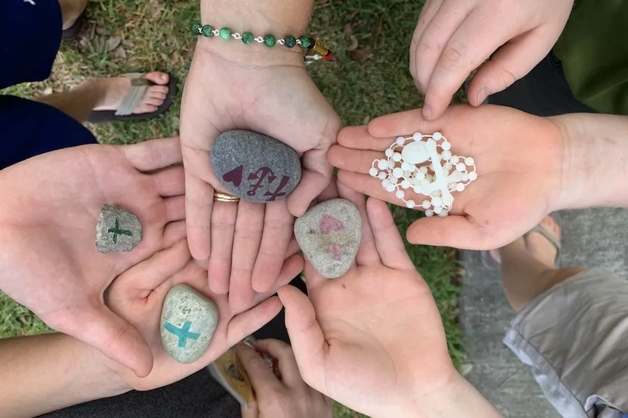 Participants at a prayer rally for priests and seminarians in New Orleans held small rocks as they prayed, which were then given to seminarians as a reminder of the prayers. ?w=200&h=150