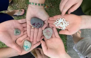 Participants at a prayer rally for priests and seminarians in New Orleans held small rocks as they prayed, which were then given to seminarians as a reminder of the prayers.   Theresa Truxillo