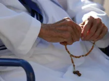 Missionary of Charity sister prays the rosary.