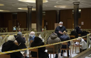 Papal almoner Cardinal Konrad Krajewski with homeless people awaiting vaccinations in the atrium of the Paul VI Hall at the Vatican Jan. 20, 2021. Credit: Vatican Media.