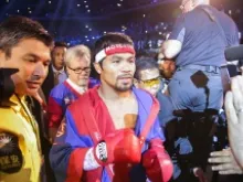 Manny Pacquiao walks into the ring before his bout with Brandon Rios in their WBO International Welterweight title fight on Nov 24, 2013 in Macau. 