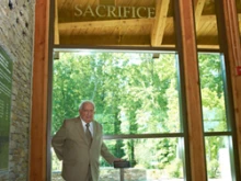Marine Cpl. James Capodanno, stands next to the window dedicated to his brother. 