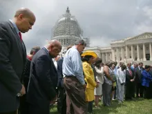 Members of Congress hold a prayer circle for Charleston shooting victims outside the White House, June 18, 2015. 
