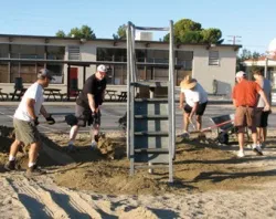 Members of Council 3199 in Ridgecrest, Calif. spread new sand at the playground at St. Ann School to ensure it meets local and state safety standards. ?w=200&h=150