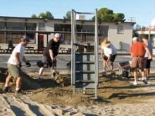 Members of Council 3199 in Ridgecrest, Calif. spread new sand at the playground at St. Ann School to ensure it meets local and state safety standards. 