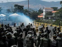 Members of the Venezuelan National Guard clash with opposition protesters on the Simon Bolivar international bridge, Feb. 24, 2019. 