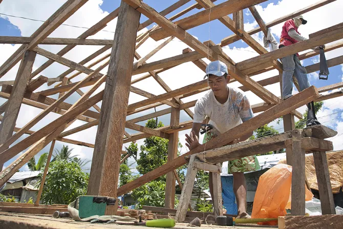 Men work on rebuilding homes in Visayas Philippines in the aftermath of Typhoon Haiyan which hit the area last November Credit Jennifer Hardy Catholic Relief Services CNA 