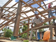 Men work on rebuilding homes in Visayas, Philippines in the aftermath of Typhoon Haiyan which hit the area last November. 