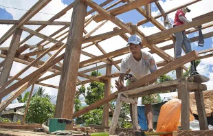 Men work on rebuilding homes in Visayas, Philippines in the aftermath of Typhoon Haiyan which hit the area last November.   Jennifer Hardy/Catholic Relief Services.